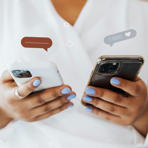 Two smartphones held by a human. Both smartphones have notification bubbles above them displaying the number of reactions relating to social media