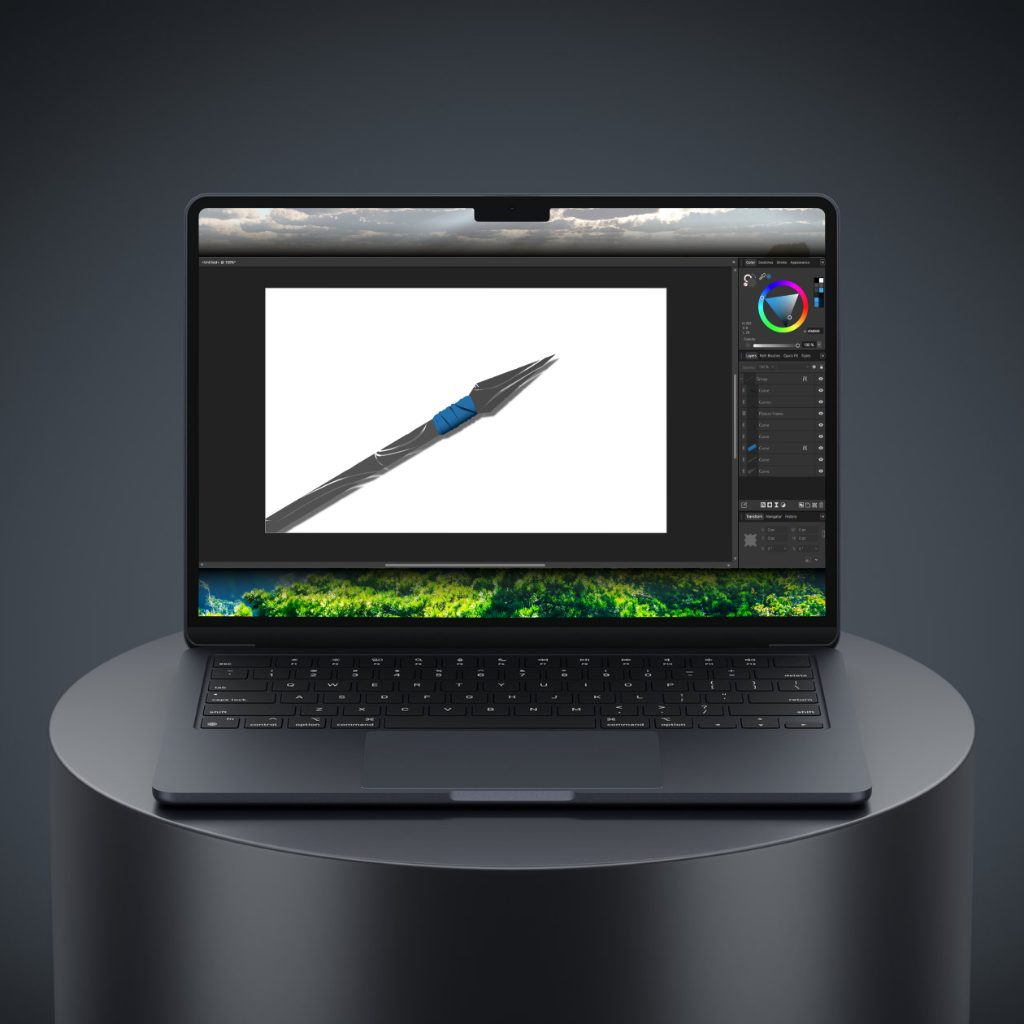 A laptop standing on a round table with a graphic design in progress